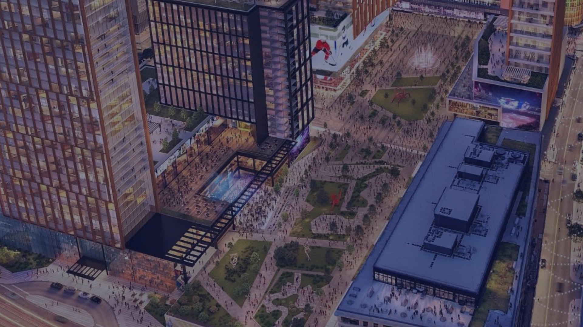 Arena-anchored mixed-use district at night — North America